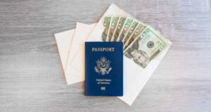 A passport and envelope cash system sit on a table. Whoever owns this stuff is definitely prepared.